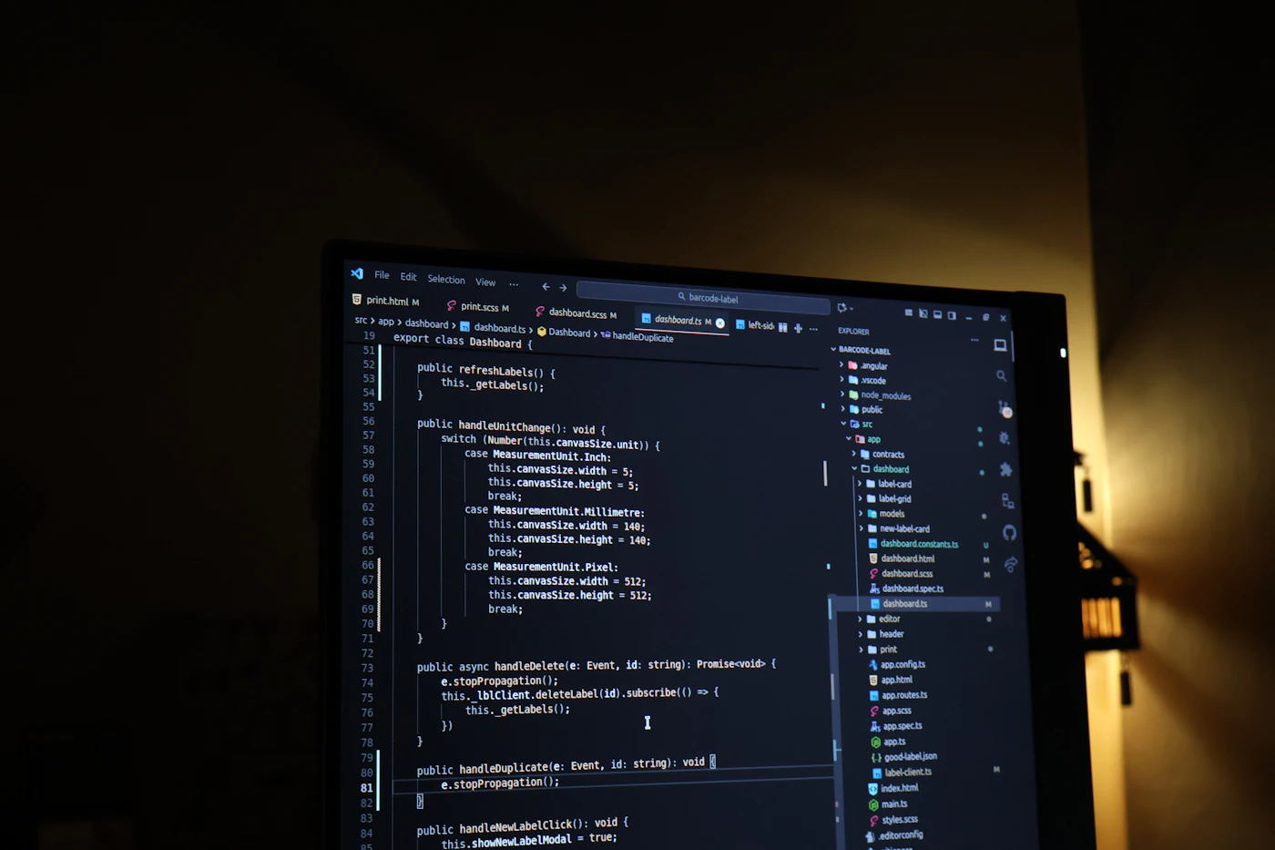 A code editor on a monitor illuminated by warm golden light